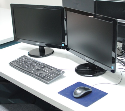A two-monitor computer setup complete with mouse and keyboard on one of the commonly used stations at 2nd Office's workspace